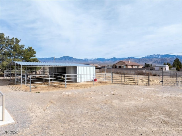 view of horse barn featuring a mountain view