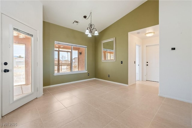 empty room featuring vaulted ceiling, light tile patterned flooring, a chandelier, and baseboards