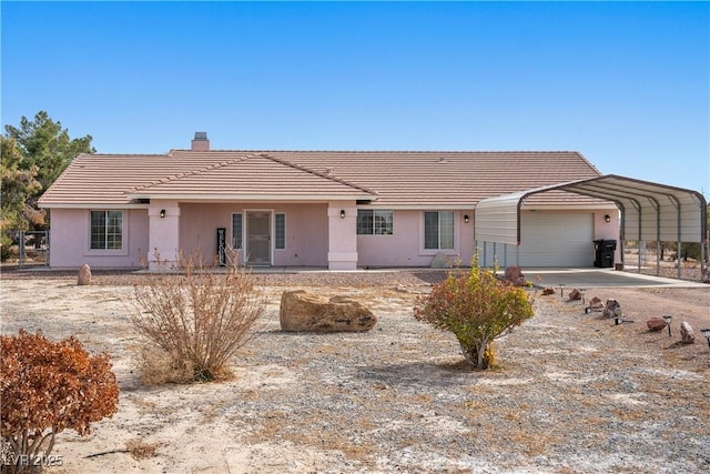 ranch-style home with an attached garage, stucco siding, a chimney, and a tiled roof