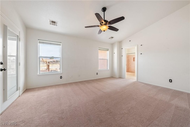 empty room featuring light colored carpet, visible vents, ceiling fan, and baseboards