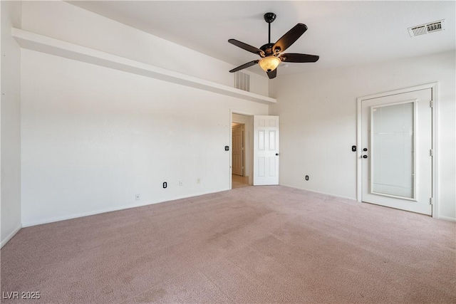 carpeted empty room with ceiling fan and visible vents