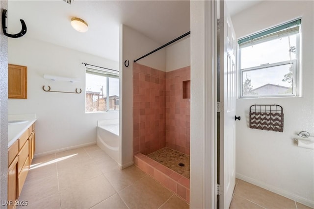 full bath featuring vanity, a tile shower, a bath, and tile patterned floors