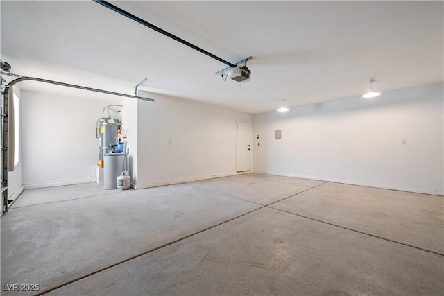 garage featuring a garage door opener and baseboards