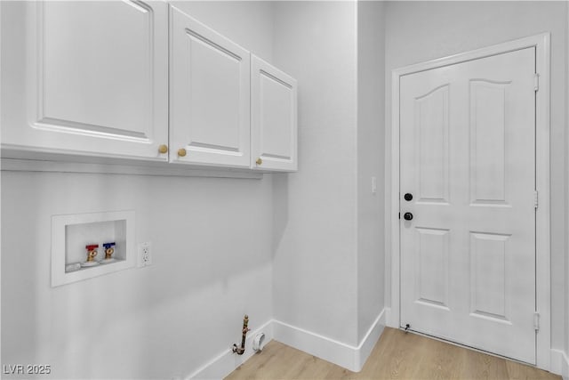 laundry area featuring hookup for a washing machine, cabinet space, gas dryer hookup, light wood-type flooring, and baseboards