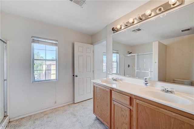 full bathroom featuring a wealth of natural light, visible vents, and a sink