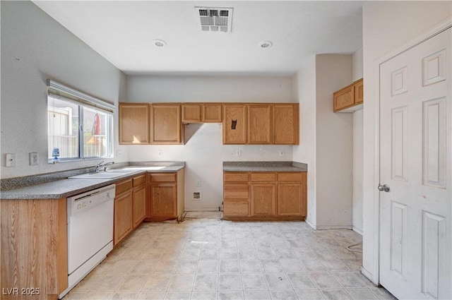 kitchen featuring white dishwasher, visible vents, brown cabinetry, and a sink