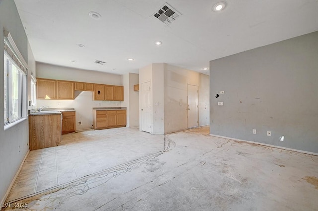 kitchen with baseboards, visible vents, light countertops, a sink, and recessed lighting