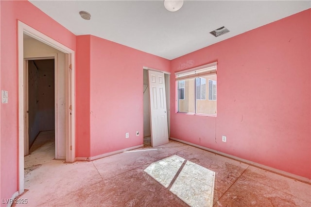 unfurnished bedroom with a closet and visible vents