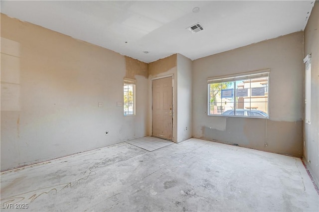 spare room featuring a wealth of natural light and visible vents