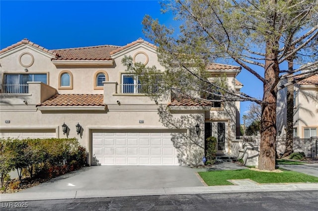 mediterranean / spanish house with a balcony, driveway, a tile roof, and stucco siding