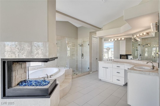 full bathroom with vaulted ceiling, a garden tub, vanity, and a shower stall