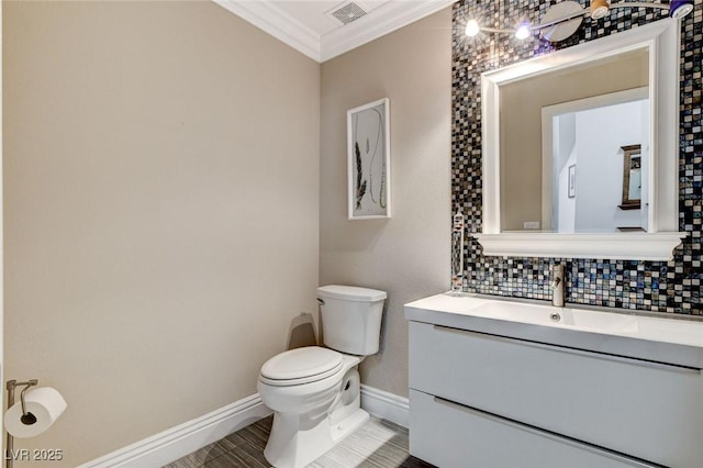 half bath with crown molding, tasteful backsplash, visible vents, toilet, and vanity