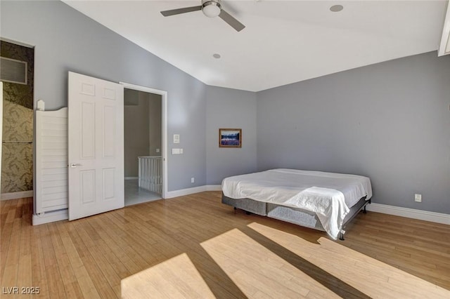 bedroom featuring lofted ceiling, light wood finished floors, ceiling fan, and baseboards