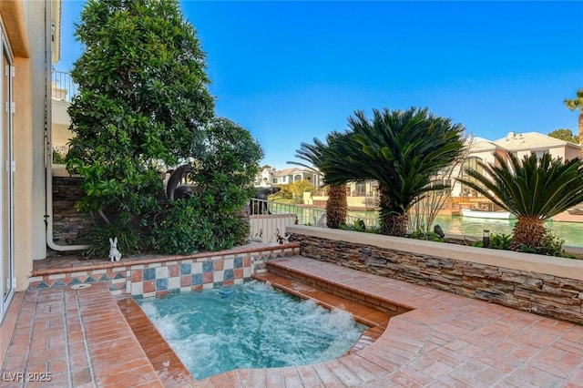 view of pool featuring an in ground hot tub, a patio, and fence