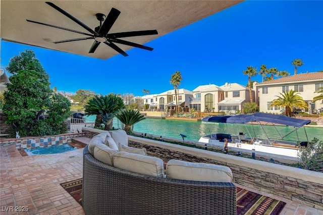 exterior space featuring outdoor lounge area, fence, a ceiling fan, a residential view, and an outdoor pool