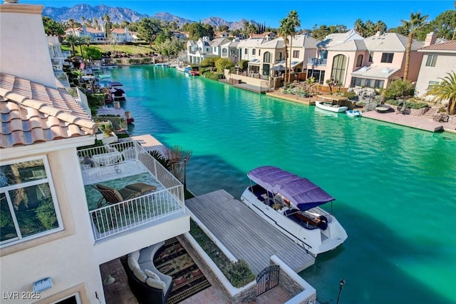 property view of water with a residential view and a mountain view