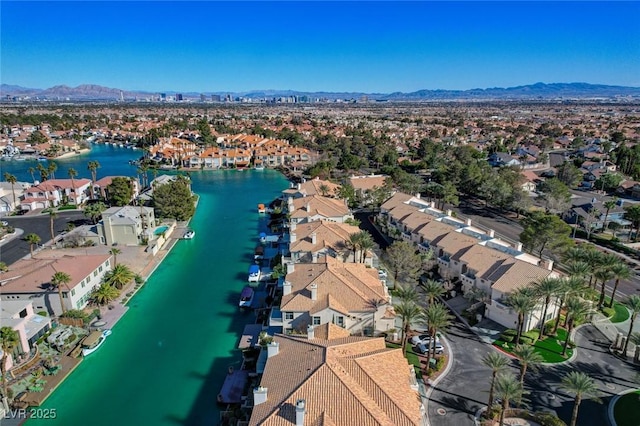 drone / aerial view featuring a residential view and a water and mountain view