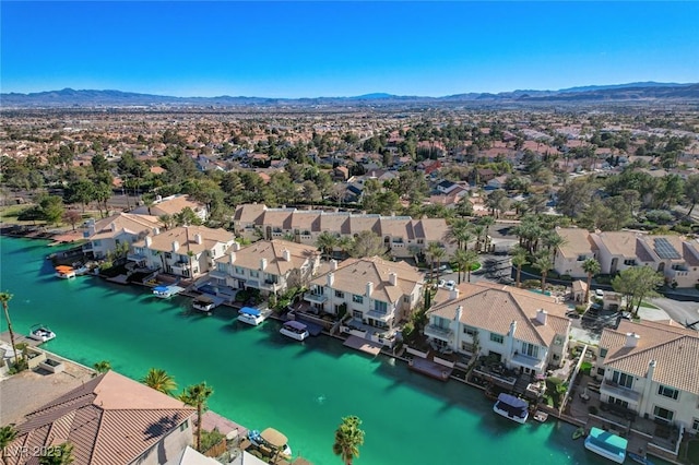 drone / aerial view with a residential view and a water and mountain view