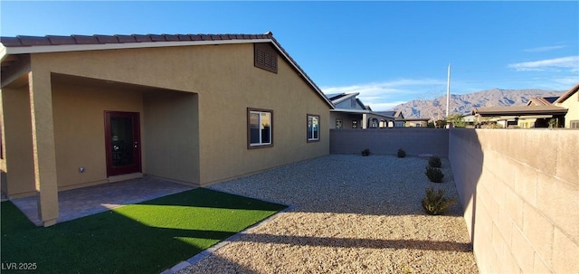 7910 Shimmery St, North Las Vegas, NV 89084 - view of side of property featuring stucco siding, a mountain view, and a patio area