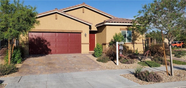 7910 Shimmery St, North Las Vegas, NV 89084 - view of front of property with stucco siding, a garage, driveway, and a tile roof