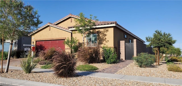 7910 Shimmery St, North Las Vegas, NV 89084 - view of front of property featuring a garage, stucco siding, and a tiled roof