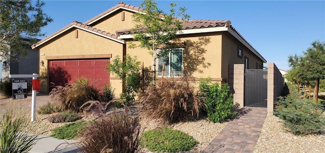 7910 Shimmery St, North Las Vegas, NV 89084 - view of front of house featuring stucco siding, a garage, and a tiled roof