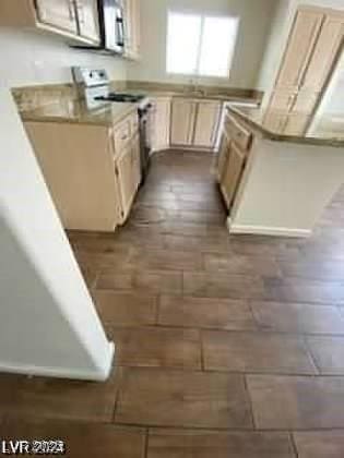 kitchen featuring white electric range oven and light countertops