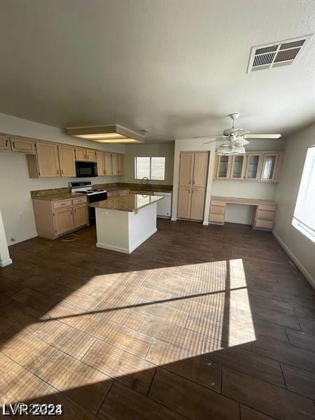 kitchen with black microwave, visible vents, a center island, electric range oven, and dark wood finished floors