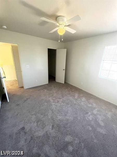 unfurnished bedroom featuring a ceiling fan and carpet