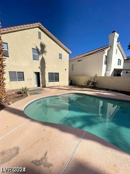 pool featuring a patio and fence