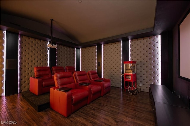 cinema room featuring dark wood-type flooring and lofted ceiling