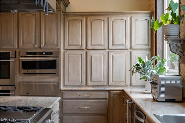 kitchen with a warming drawer, light countertops, and double oven