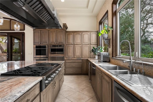 kitchen with stainless steel appliances, a sink, and light tile patterned floors