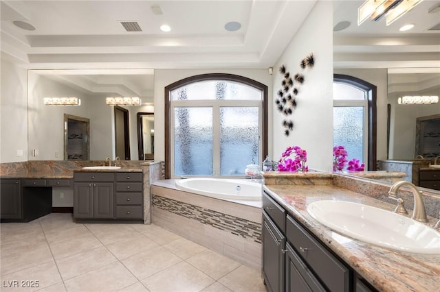 full bathroom with tile patterned flooring, visible vents, a sink, and a bath