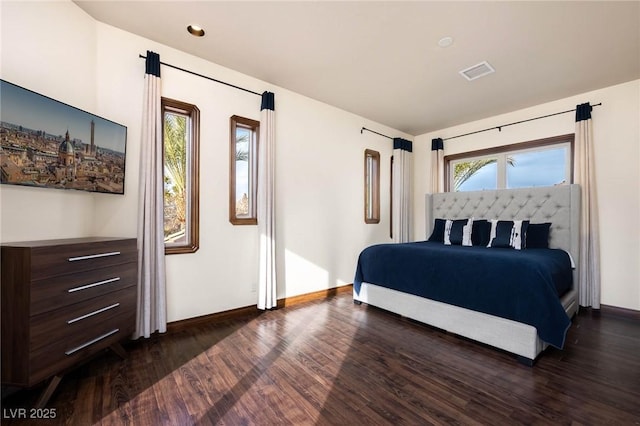 bedroom with baseboards, visible vents, and dark wood-type flooring