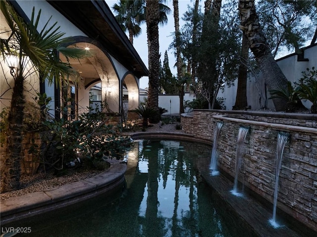 view of swimming pool featuring fence and a fenced in pool