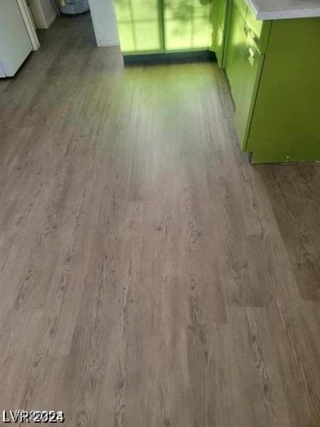 interior details featuring green cabinetry and wood finished floors