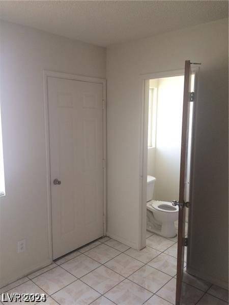 bathroom with tile patterned flooring and toilet