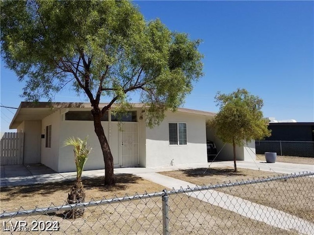 single story home featuring fence and stucco siding