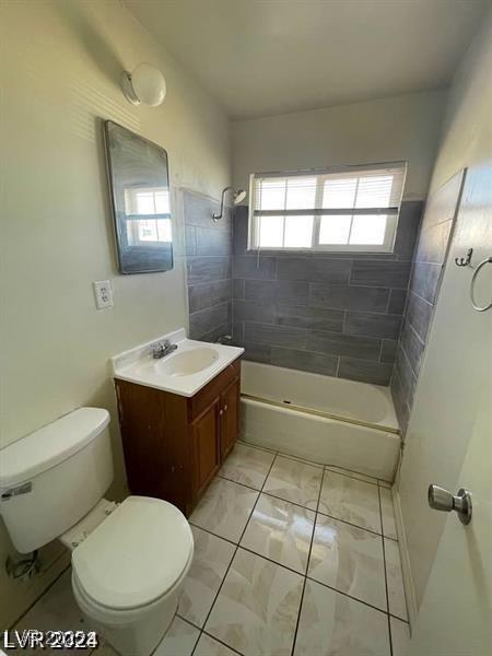 bathroom featuring shower / tub combination, vanity, and toilet