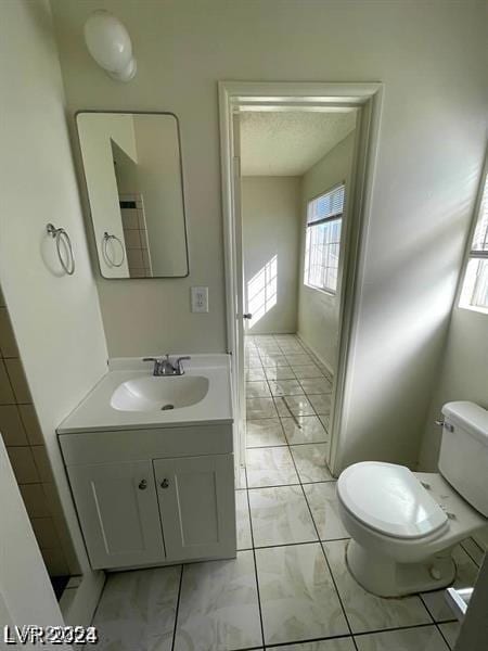 bathroom featuring marble finish floor, vanity, and toilet