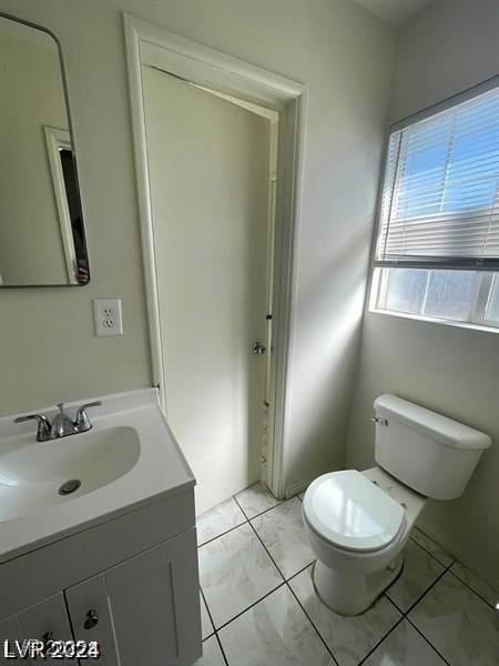 half bathroom with toilet and vanity