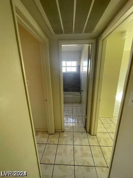 hall with light tile patterned floors