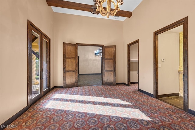 hall featuring a notable chandelier, baseboards, beam ceiling, and french doors