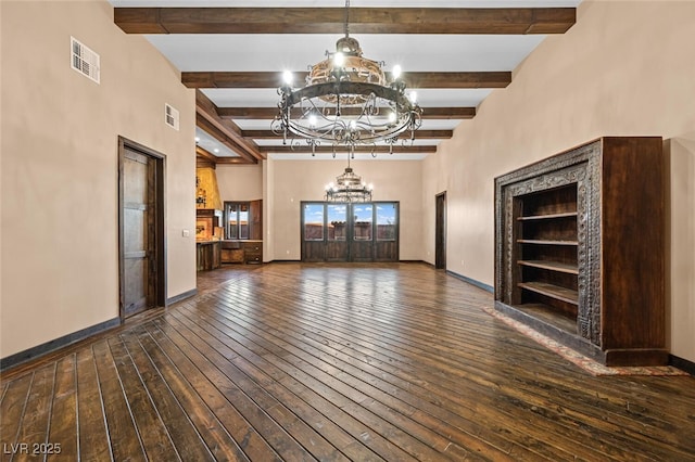 unfurnished living room with a chandelier, wood-type flooring, visible vents, and baseboards