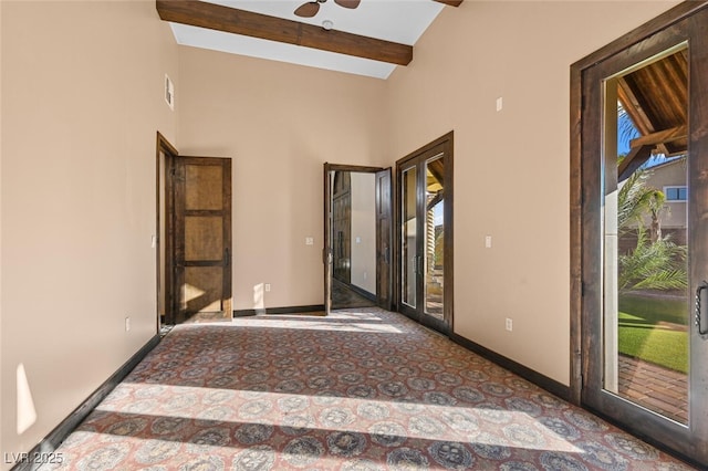 unfurnished room with high vaulted ceiling, beamed ceiling, and baseboards