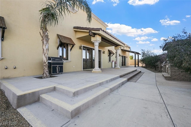 exterior space with a patio and stucco siding