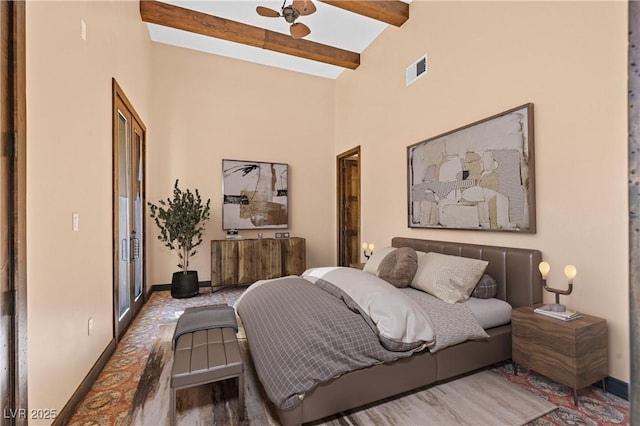 bedroom featuring high vaulted ceiling, visible vents, beamed ceiling, and baseboards