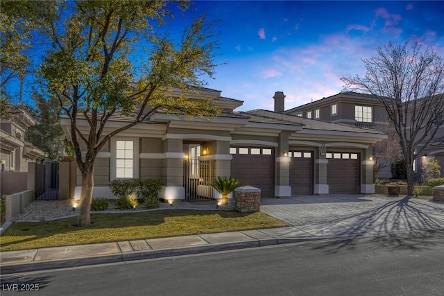 view of front of home with a garage, decorative driveway, and stucco siding