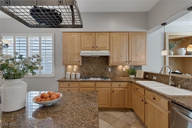 kitchen featuring stainless steel dishwasher, light brown cabinetry, under cabinet range hood, white gas cooktop, and a sink